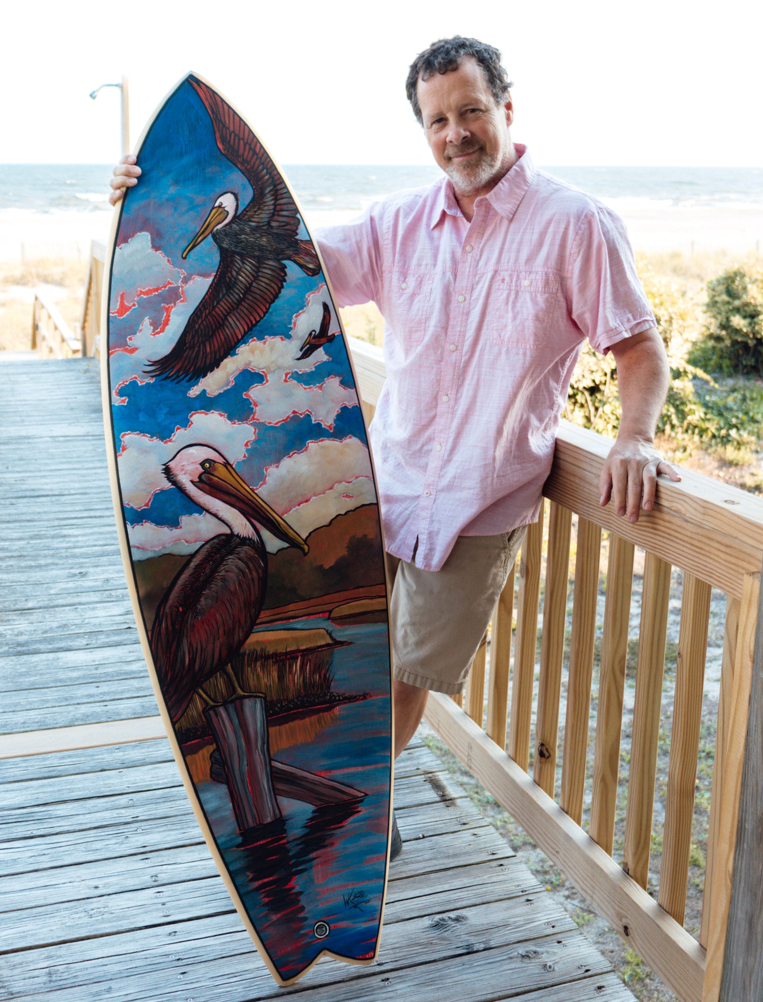 William Keith White Artist holding custom painted surfboard